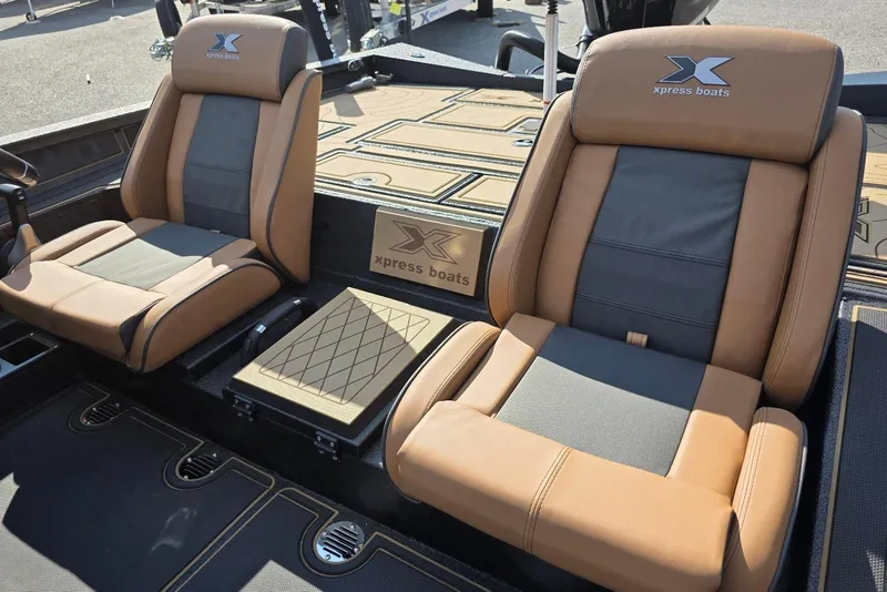 Slide: The Image of 2026 Xpress X19 Pro Bass boat interior with tan and gray seating. - 10