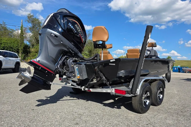 Slide: The Image of 2026 Xpress X19 Pro Bass boat with Yamaha Vmax 200 SHO engine, parked outdoors. - 21