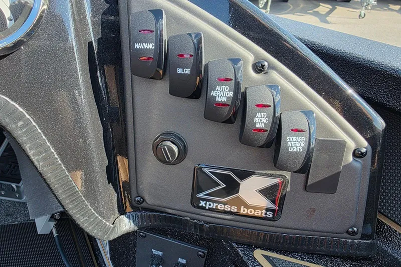 Slide: The Image of Control panel of 2026 Xpress X19 Pro Bass boat with labeled switches. - 8
