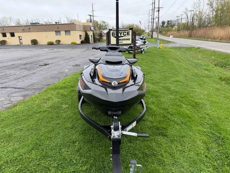 Slide: The Image of 2022 Sea-Doo GTX 170 jet ski on trailer, parked on grass near a road. - 3