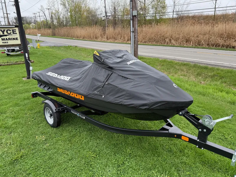 Slide: The Image of 2022 Sea-Doo GTX 170 with cover on trailer, parked on grass. - 7