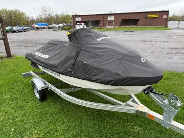 Slide: The Image of 2024 Sea-Doo GTX Limited 300 on trailer, covered, parked on grass. - 8