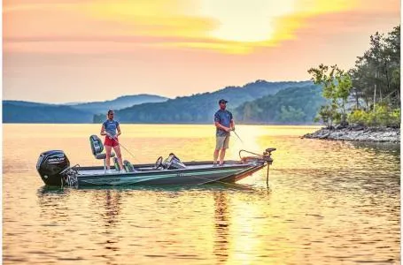 Slide: The Image of Two people fishing on a 2025 Ranger RT178 boat at sunset on a serene lake. - 20