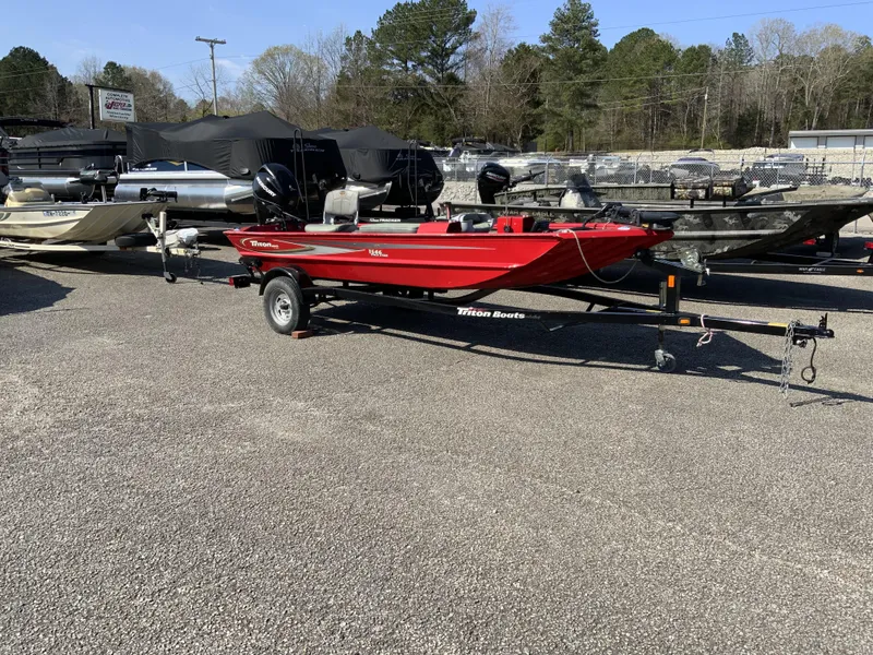Slide: The Image of 2006 Triton 1546 SS red boat on trailer in outdoor lot. - 1