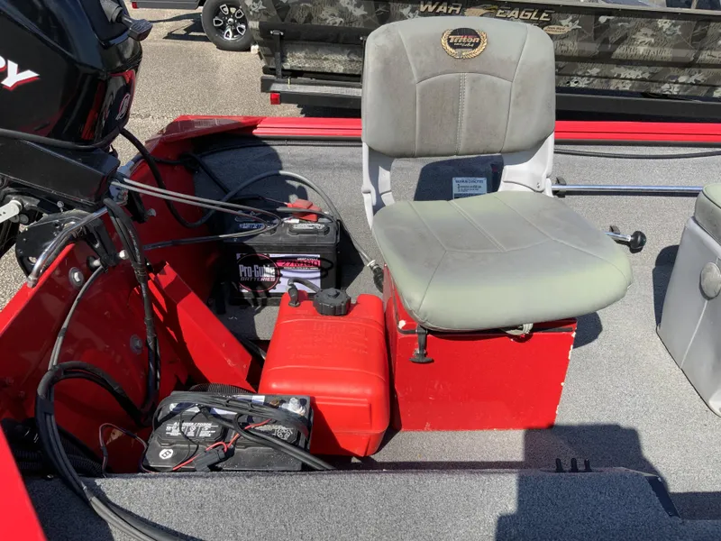 Slide: The Image of 2006 Triton 1546 SS boat interior with seat, battery, and motor components. - 10