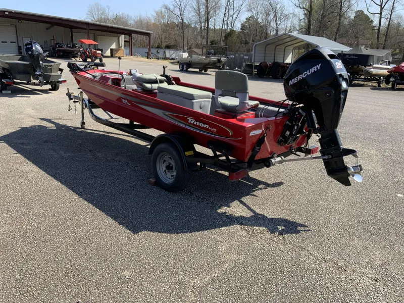 Slide: The Image of 2006 Triton 1546 SS red boat with Mercury engine on trailer. - 2