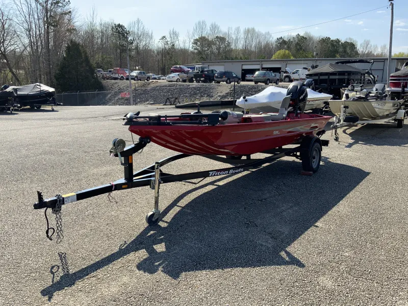 Slide: The Image of 2006 Triton 1546 SS red boat on trailer in parking lot. - 6