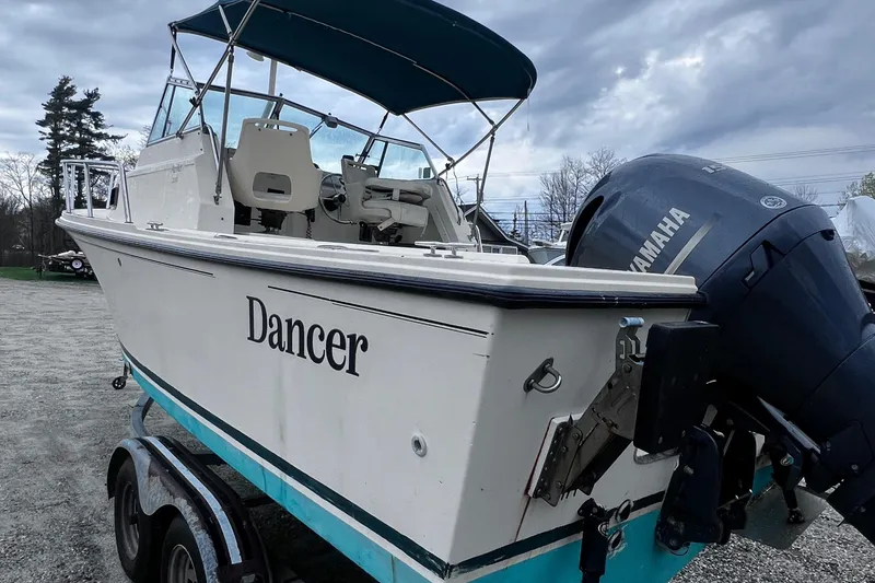 Slide: The Image of 1999 Parker 21 Cuddy Cabin boat named "Dancer" with Yamaha outboard motor on trailer. - 2