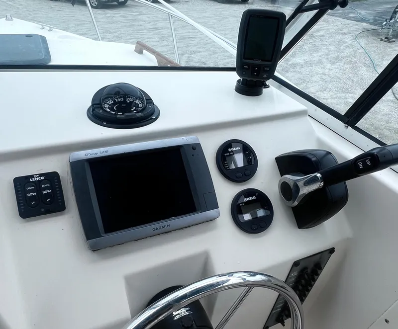 Slide: The Image of Control panel of a 1999 Parker 21 Cuddy Cabin boat with navigation instruments. - 8