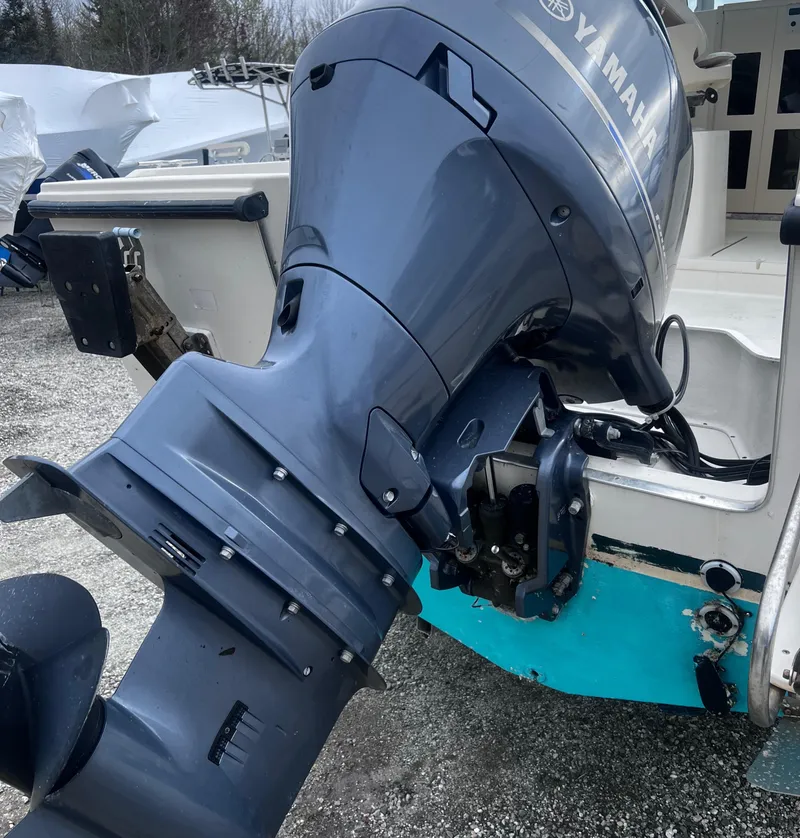 Slide: The Image of 1999 Parker 21 Cuddy Cabin with Yamaha outboard motor, parked on gravel. - 9