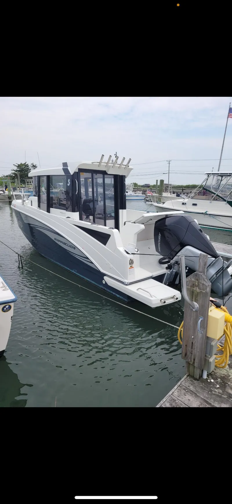 Slide: The Image of 2020 Beneteau BARRACUDA 8 boat docked in marina, side view. - 12