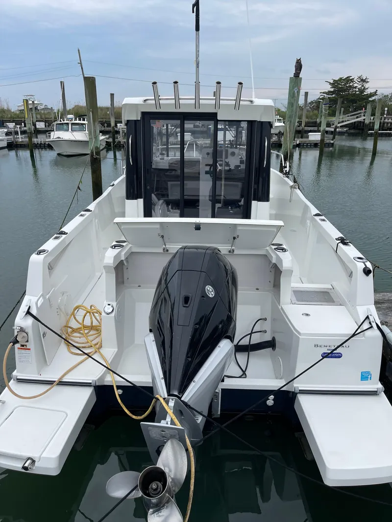 Slide: The Image of 2020 Beneteau BARRACUDA 8 boat docked, featuring a powerful outboard motor. - 14
