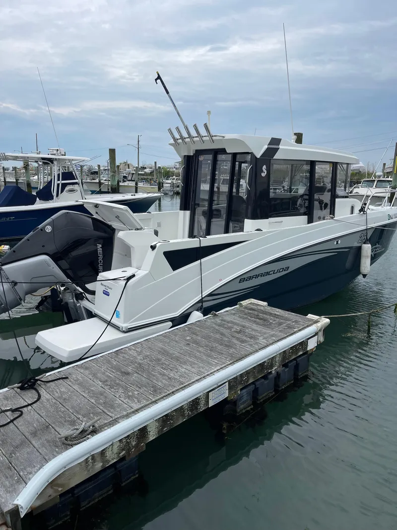 Slide: The Image of 2020 Beneteau Barracuda 8 docked at marina, showcasing sleek design and modern features. - 15
