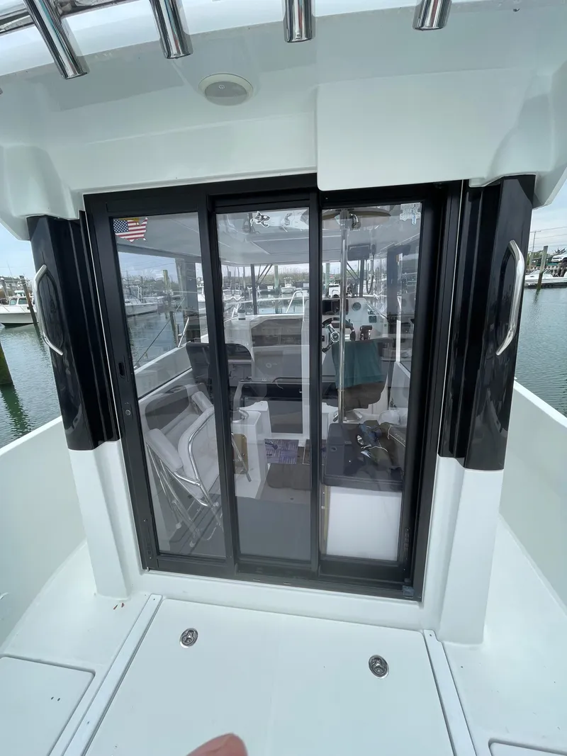 Slide: The Image of 2020 Beneteau Barracuda 8 boat with sliding glass door, docked at marina. - 17