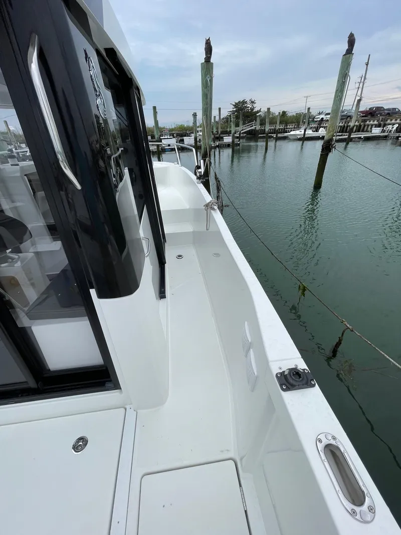 Slide: The Image of 2020 Beneteau Barracuda 8 boat docked, showcasing sleek deck design and marina view. - 18