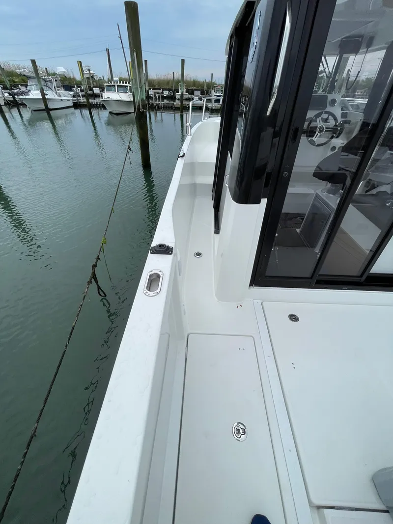 Slide: The Image of 2020 Beneteau Barracuda 8 boat docked, showcasing side deck and cabin entrance. - 19