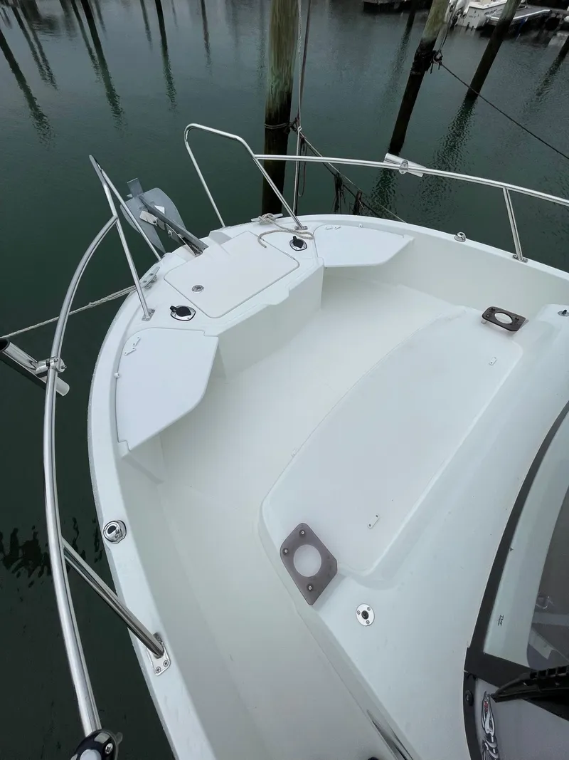 Slide: The Image of 2020 Beneteau BARRACUDA 8 boat deck with railing, docked in calm waters. - 20
