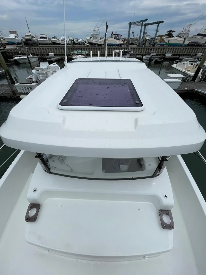 Slide: The Image of Beneteau Barracuda 8, 2020 model, docked at marina, top view of cabin roof. - 23