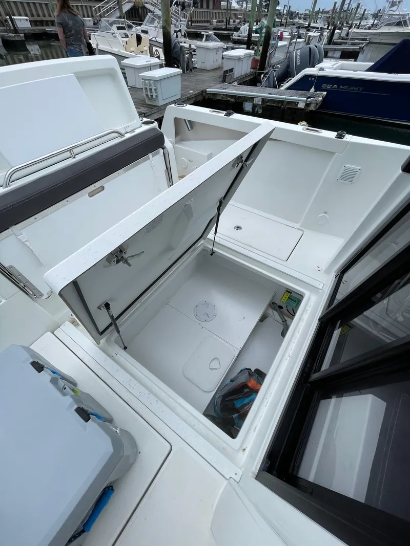 Slide: The Image of Beneteau BARRACUDA 8 (2020) boat storage compartment open at marina. - 27