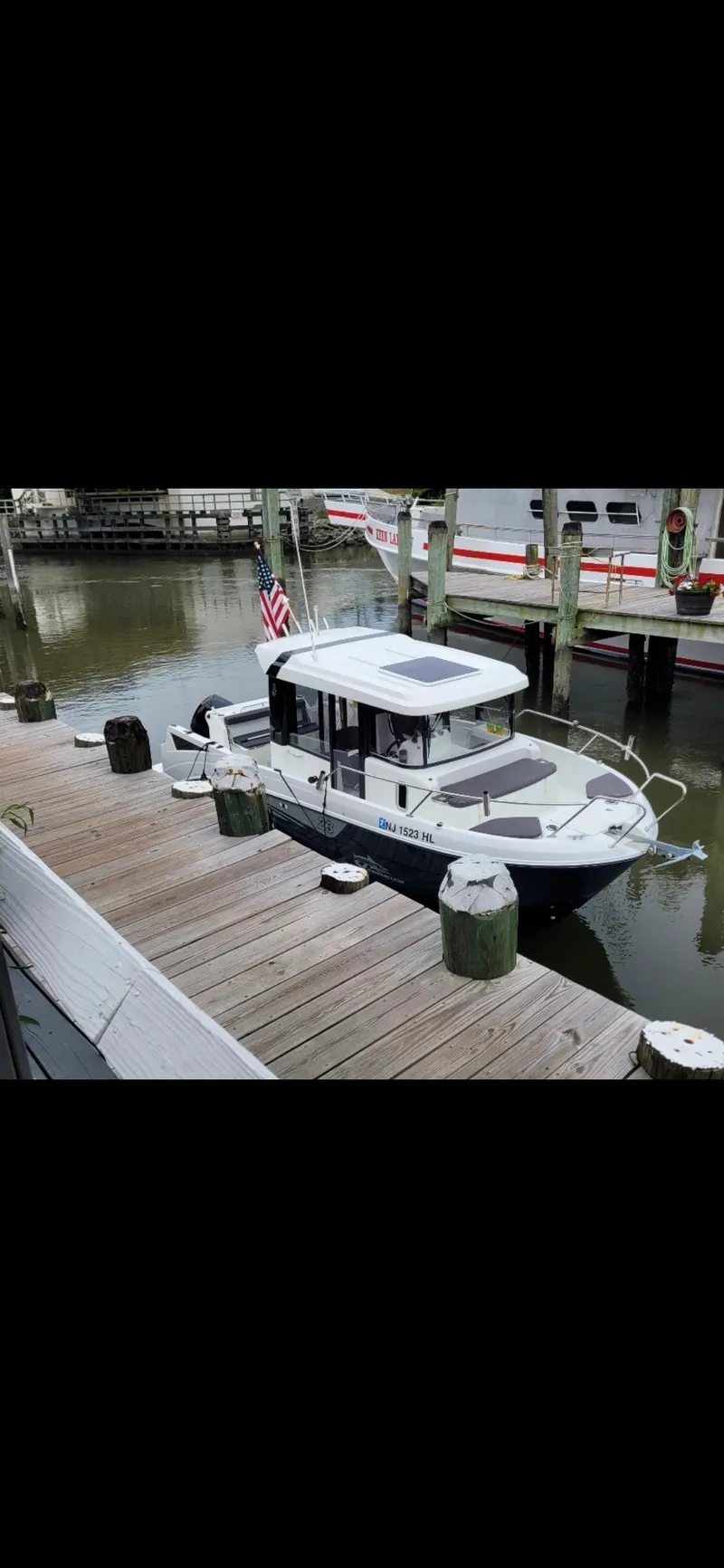 Slide: The Image of 2020 Beneteau Barracuda 8 docked at a marina, featuring sleek design and modern amenities. - 3