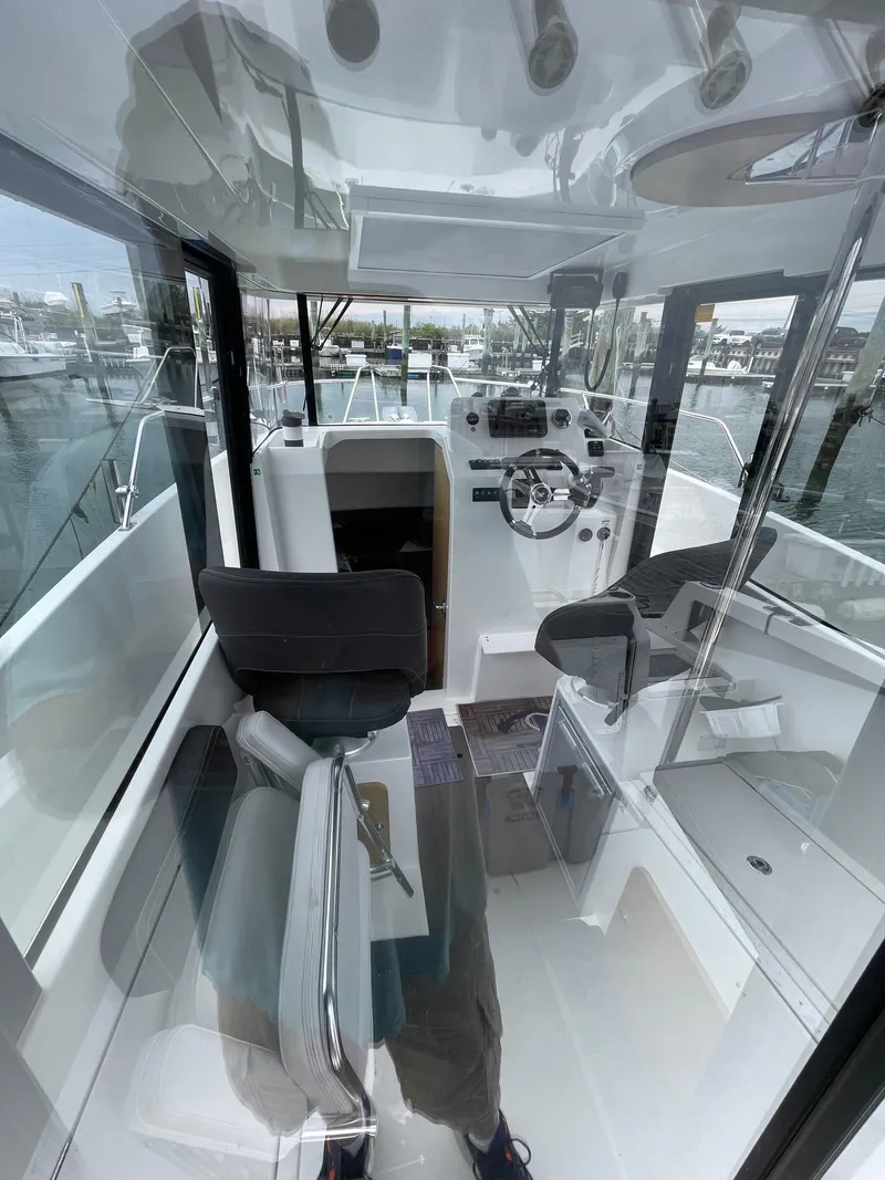 Slide: The Image of Interior view of 2020 Beneteau BARRACUDA 8 boat, showcasing helm and seating area. - 32