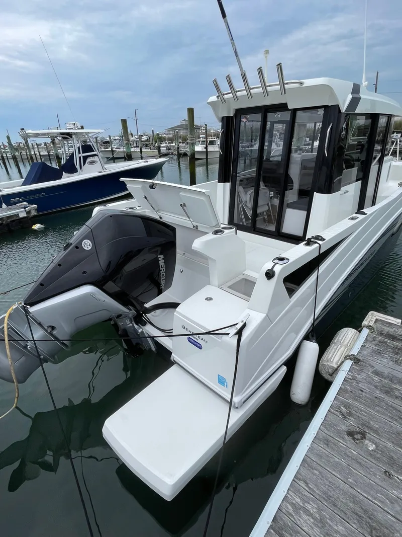 Slide: The Image of 2020 Beneteau Barracuda 8 boat docked in marina, featuring sleek design and powerful outboard motor. - 35
