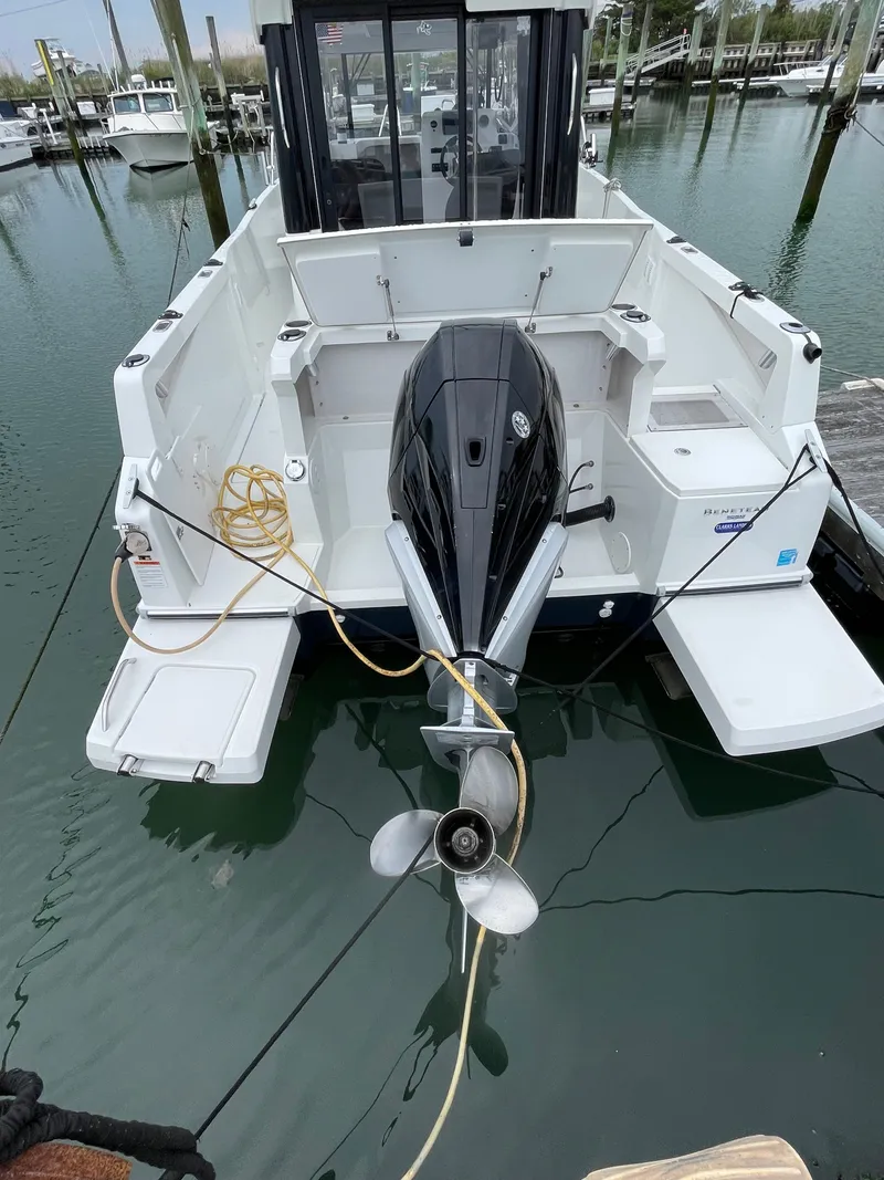 Slide: The Image of Beneteau BARRACUDA 8, 2020 model, docked with outboard motor, rear view. - 36