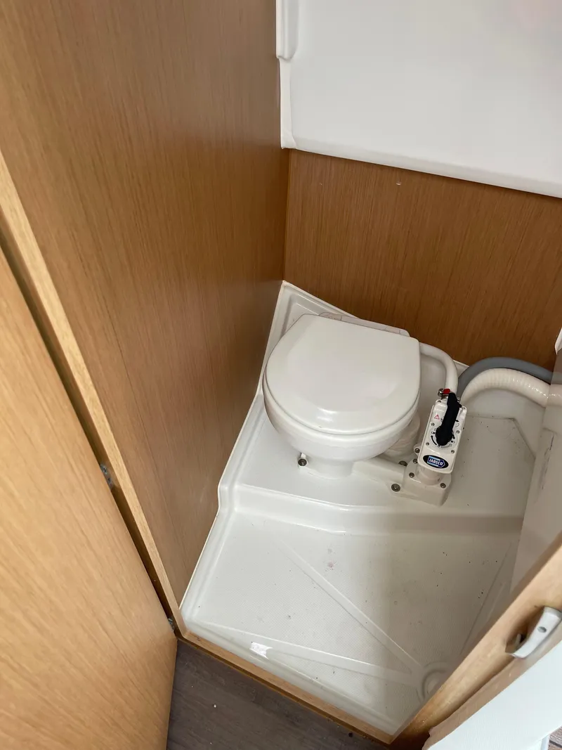 Slide: The Image of Compact marine toilet in 2020 Beneteau Barracuda 8 boat, featuring wooden paneling. - 37