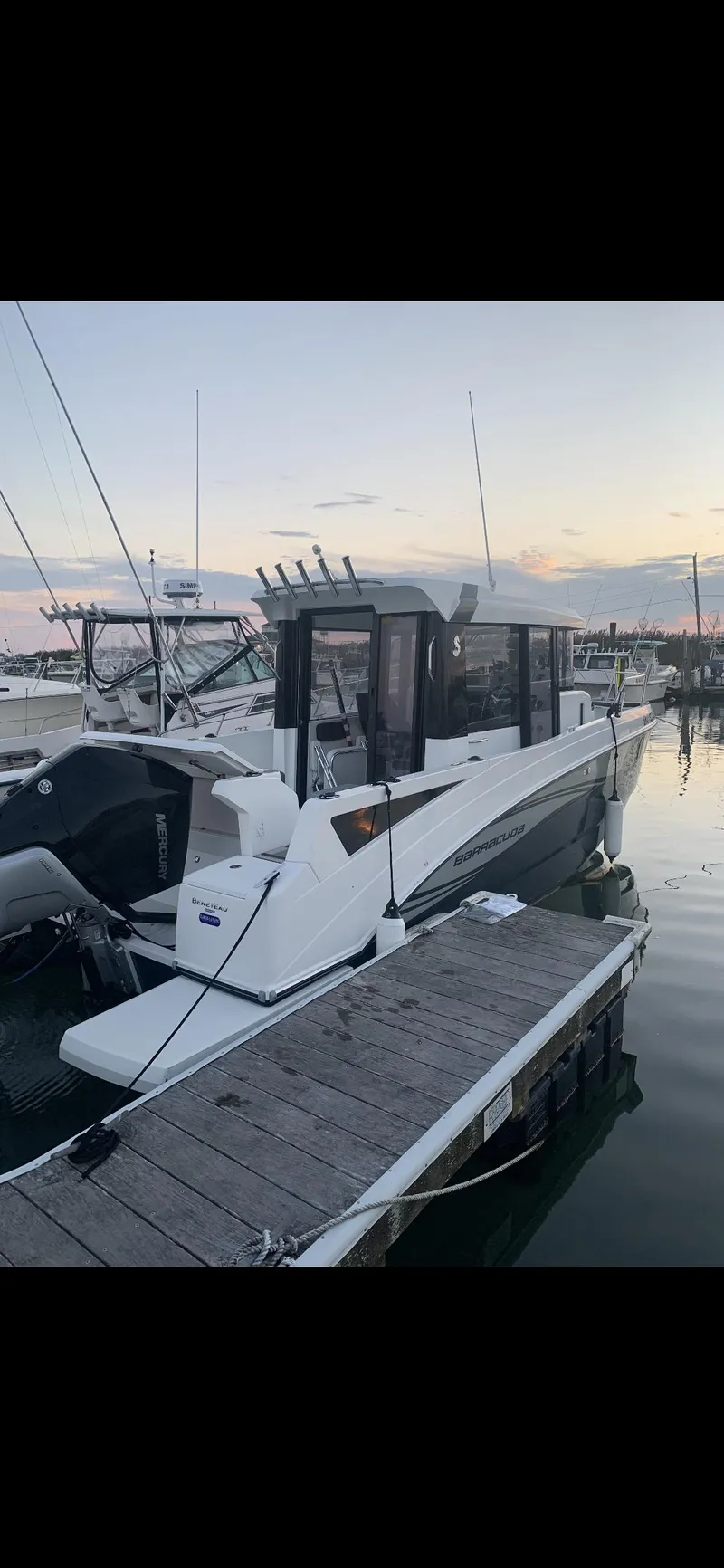 Slide: The Image of 2020 Beneteau Barracuda 8 boat docked at sunset, featuring sleek design and modern amenities. - 4