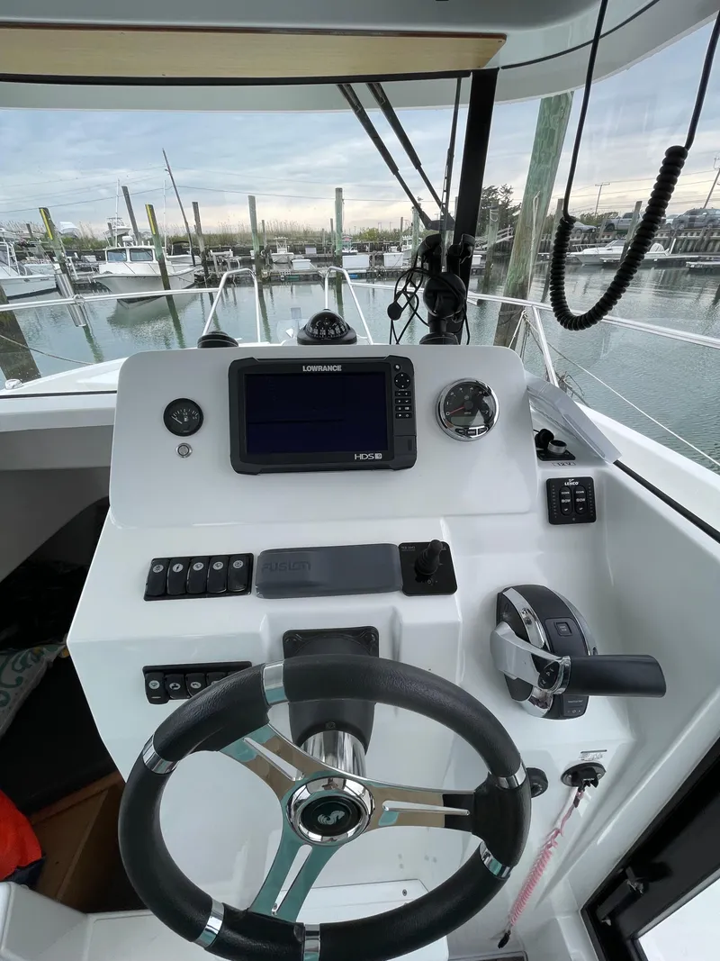 Slide: The Image of 2020 Beneteau Barracuda 8 helm with navigation system, steering wheel, and controls. - 42