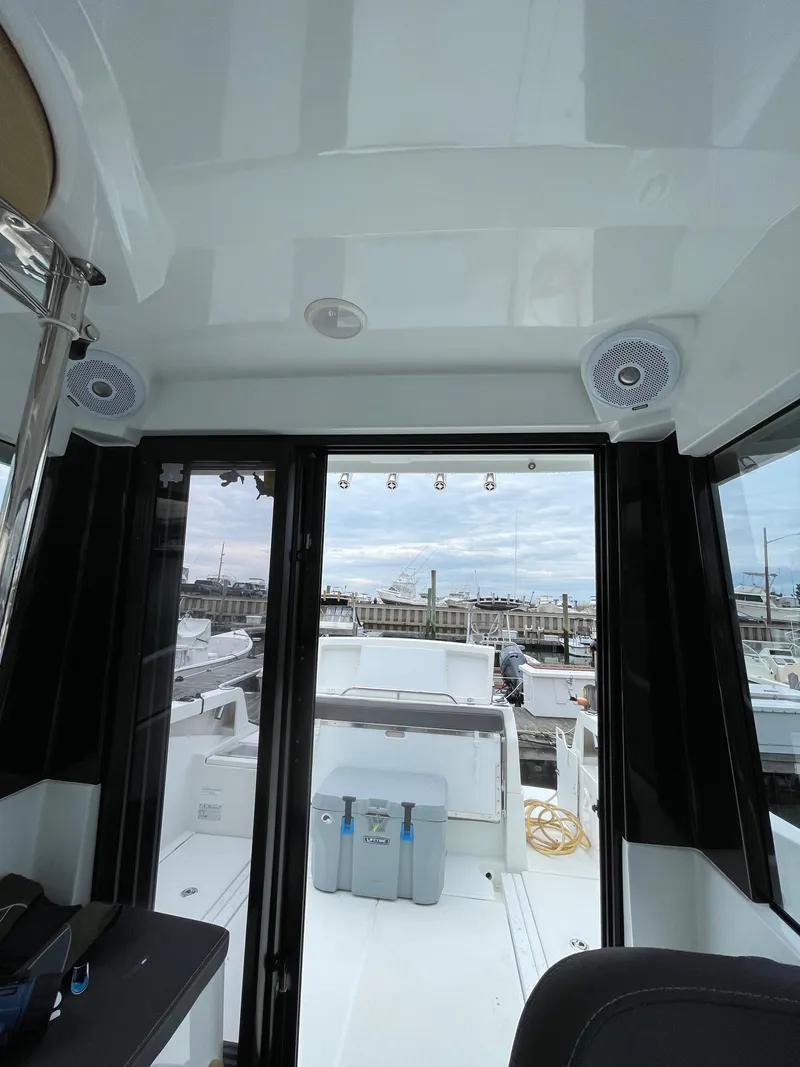 Slide: The Image of Interior view of 2020 Beneteau BARRACUDA 8 boat, showcasing sleek design and marina backdrop. - 48