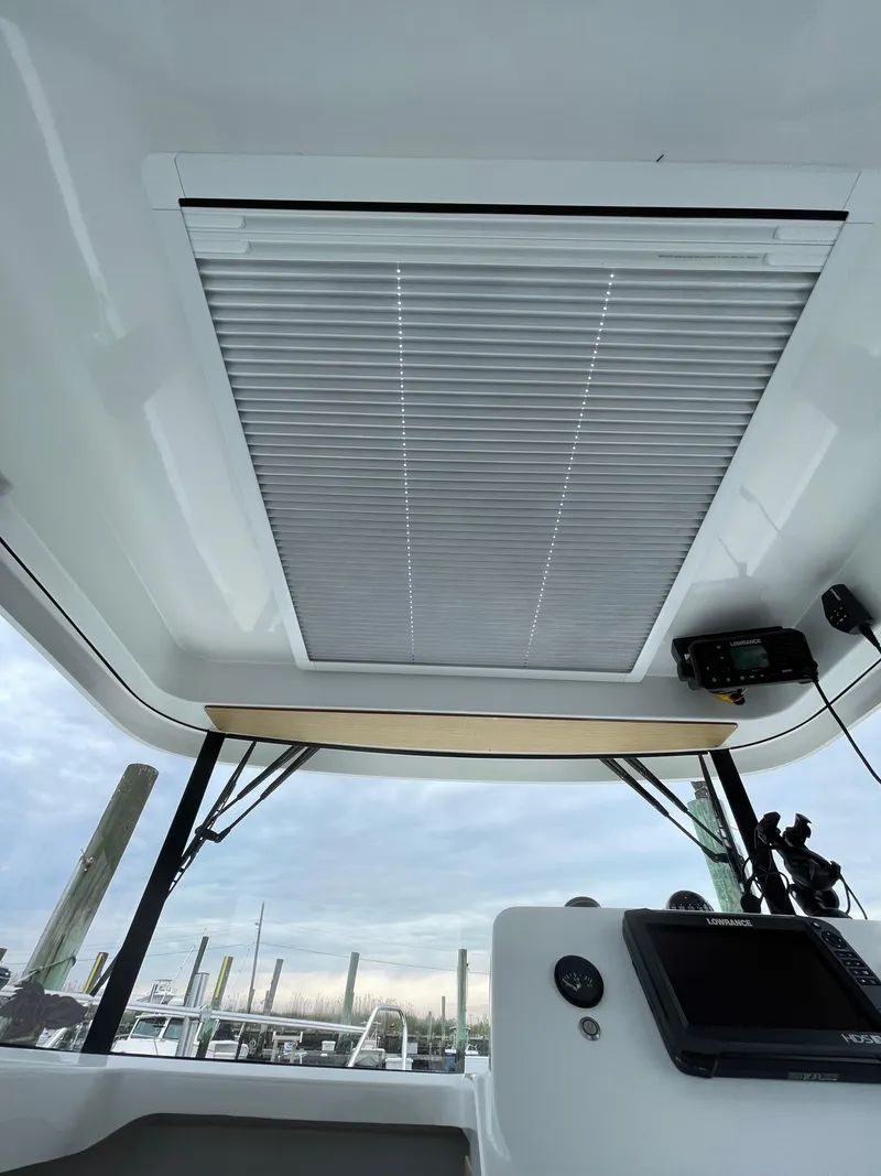 Slide: The Image of Interior view of 2020 Beneteau BARRACUDA 8 boat with modern controls and window blinds. - 49