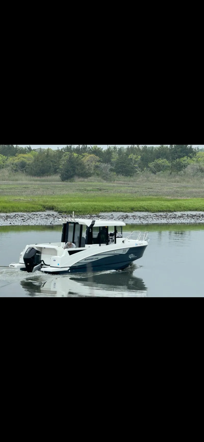 Slide: The Image of 2020 Beneteau Barracuda 8 boat cruising on a calm lake. - 5