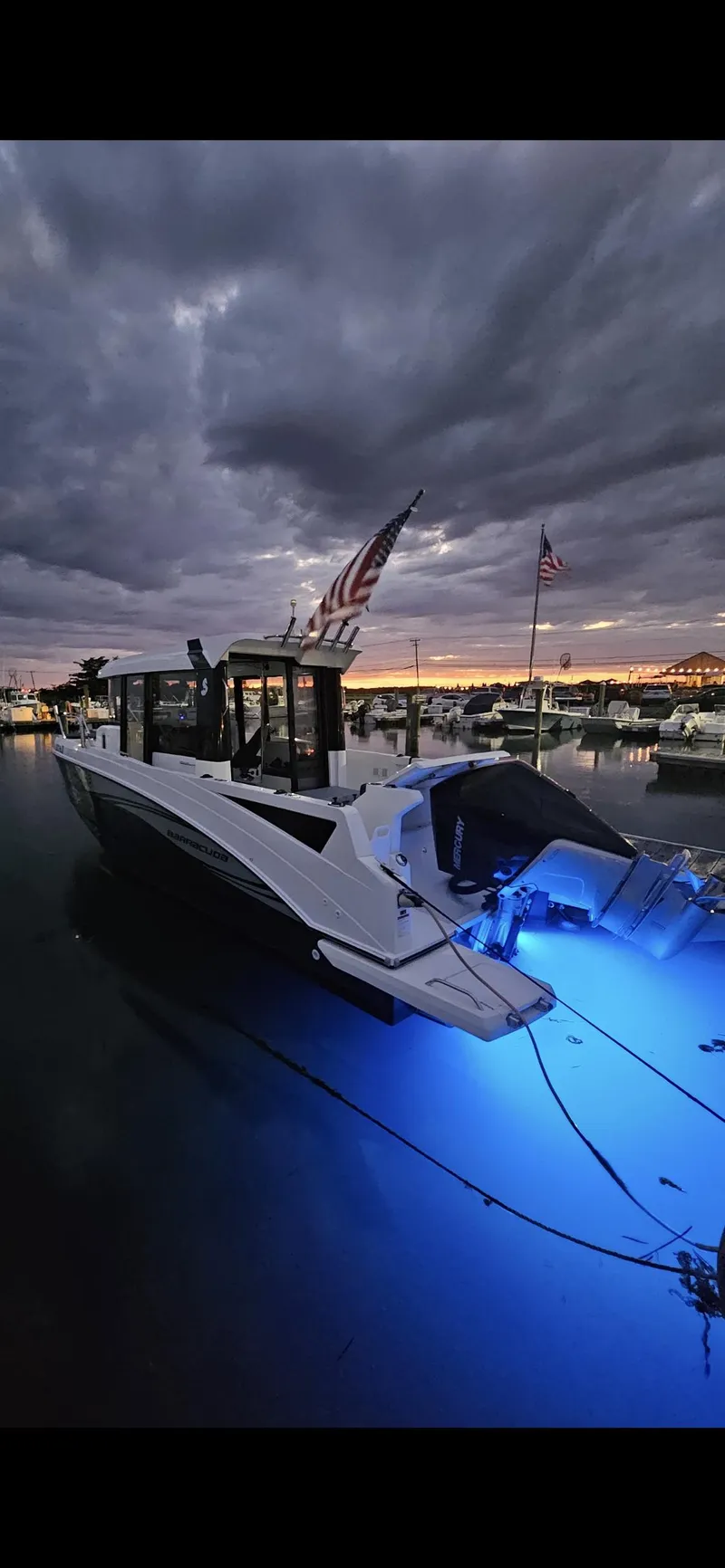 Slide: The Image of Beneteau BARRACUDA 8 boat, 2020 model, docked at sunset with blue underwater lights. - 7