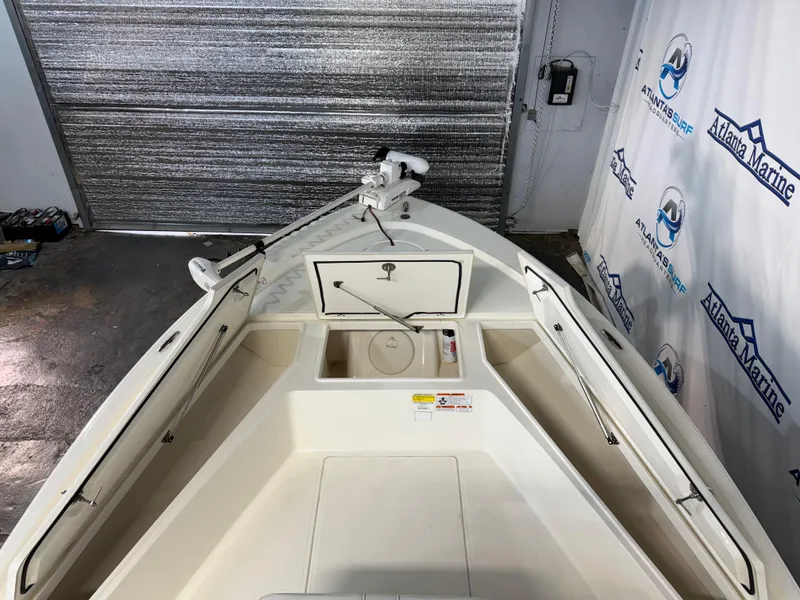 Slide: The Image of 2020 Mako 21 LTS boat interior with storage compartments open, displayed at Atlanta Marine. - 13
