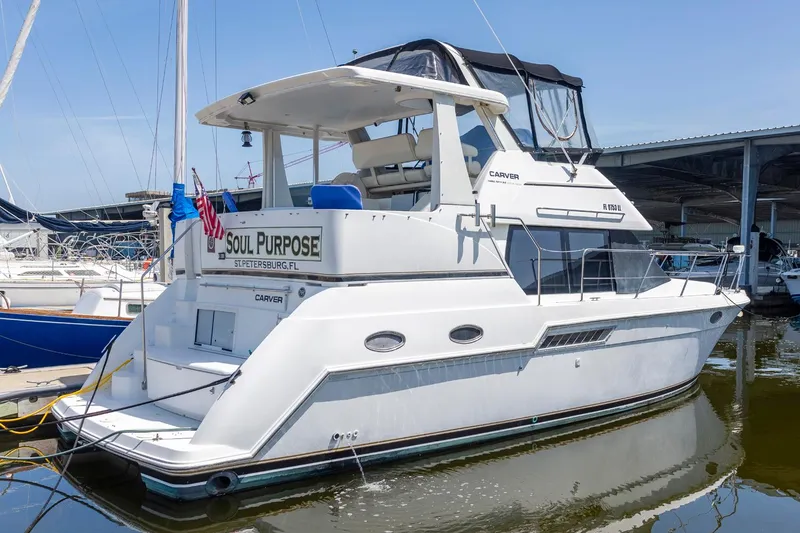 The Image of 2000 Carver 356 Aft Cabin Motor Yacht docked in marina, featuring spacious deck and cabin. - 0