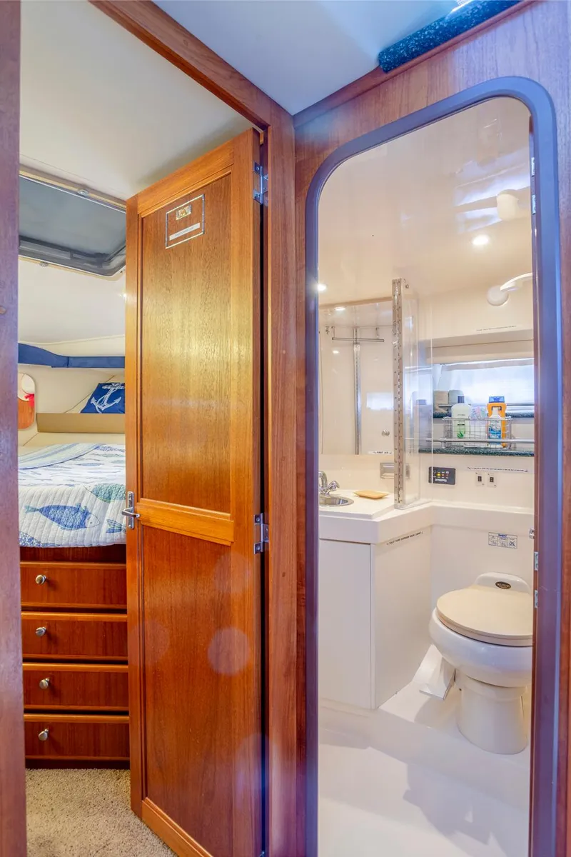 Slide: The Image of Luxurious cabin interior of 2000 Carver 356 Aft Cabin Motor Yacht with cozy bed and TV. - 12