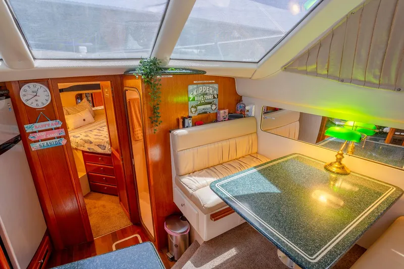 Slide: The Image of Interior of 2000 Carver 356 Aft Cabin Motor Yacht with beige leather seating. - 17