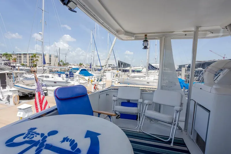 Slide: The Image of 2000 Carver 356 Aft Cabin Motor Yacht docked, featuring outdoor seating and marina view. - 4