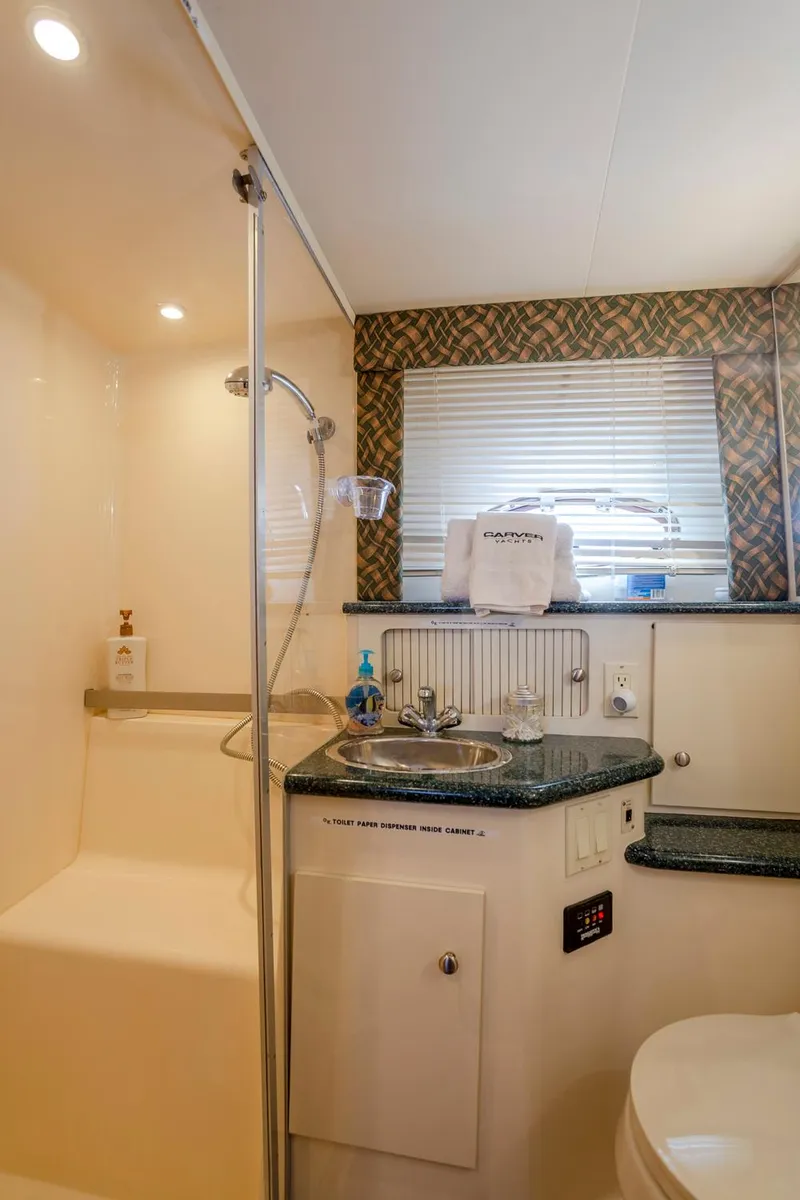Slide: The Image of Bathroom interior of 2000 Carver 356 Aft Cabin Motor Yacht, featuring sink and shower. - 9