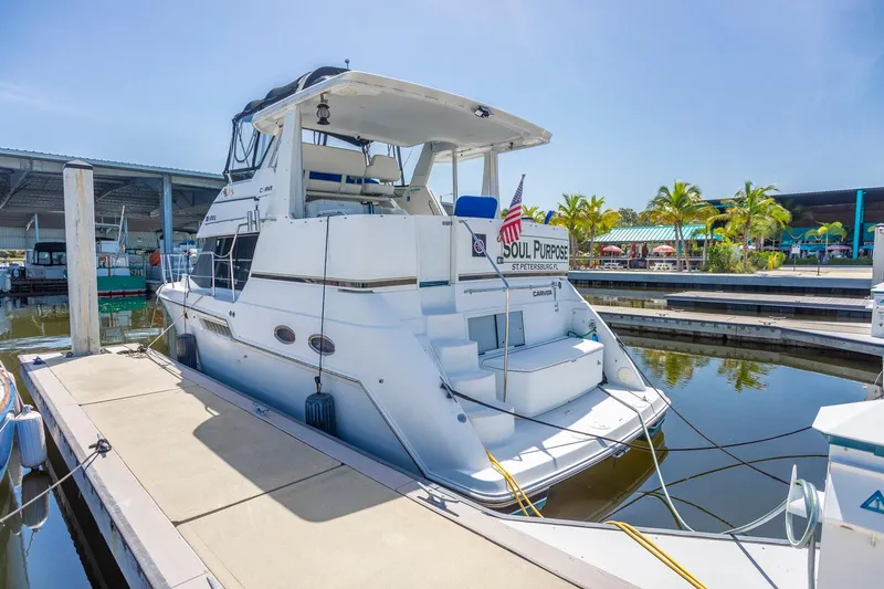 Slide: The Image of 2000 Carver 356 Aft Cabin Motor Yacht docked at marina under clear sky. - 2
