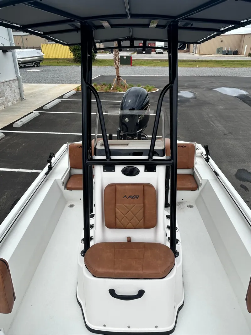 Slide: The Image of 2025 Avid 22 Recon boat interior with brown seating and black T-top. - 13