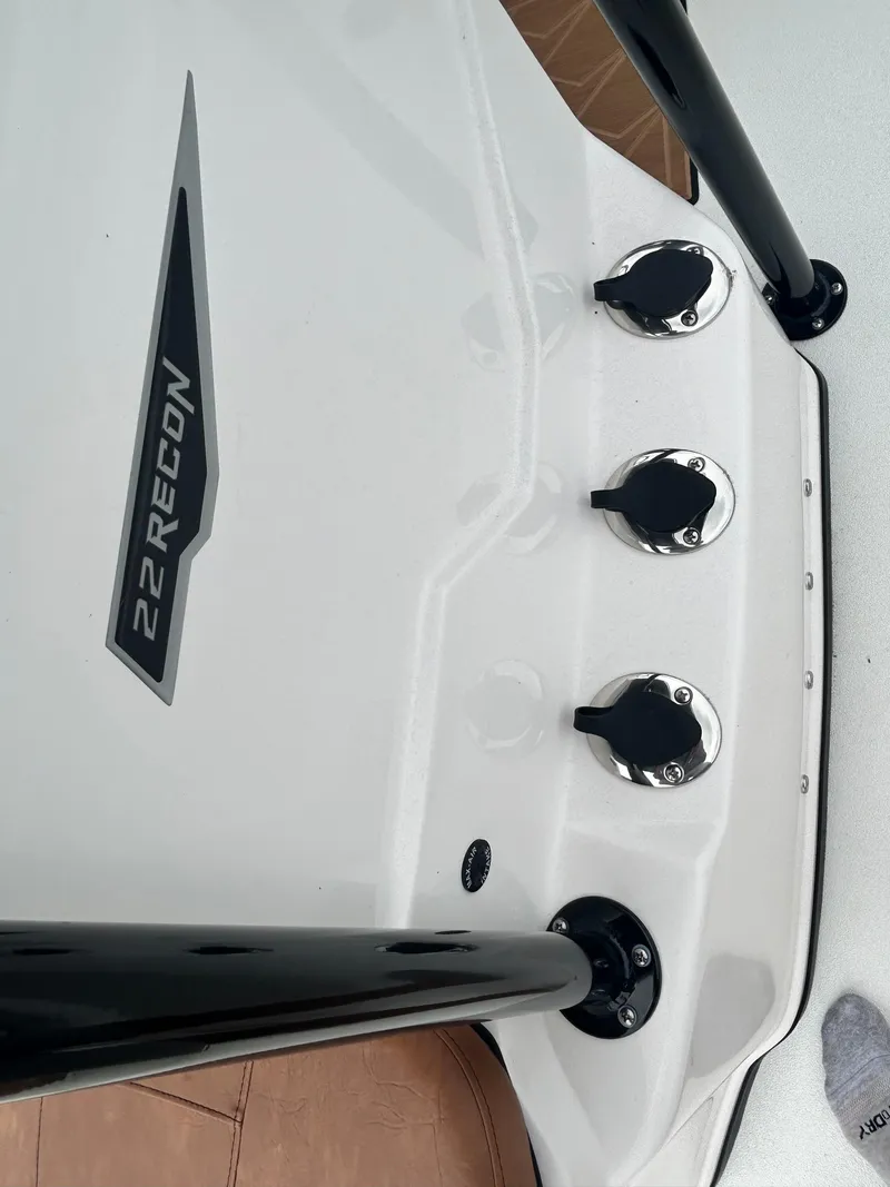 Slide: The Image of Avid 22 Recon 2025 boat deck with rod holders and logo. - 15