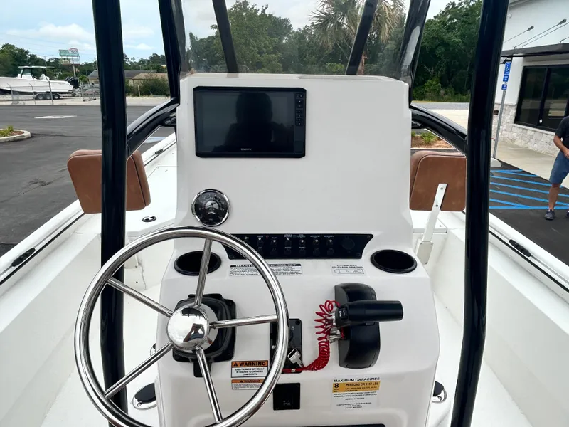 Slide: The Image of 2025 Avid 22 Recon boat dashboard with steering wheel and navigation display. - 16