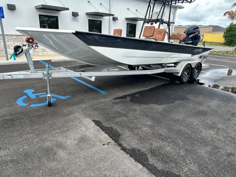 Slide: The Image of Avid 22 Recon 2025 boat on trailer in parking lot near building. - 17