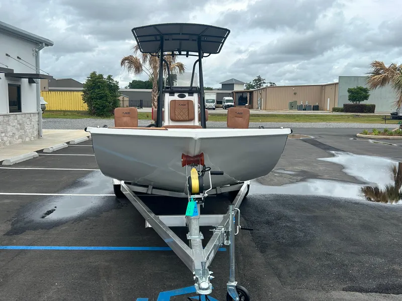 Slide: The Image of Avid 22 Recon 2025 boat on trailer in parking lot, overcast sky. - 6