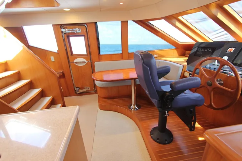 Slide: The Image of Pilothouse interior of 2001 Symbol 62 yacht with wooden finishes and ocean view. - 13