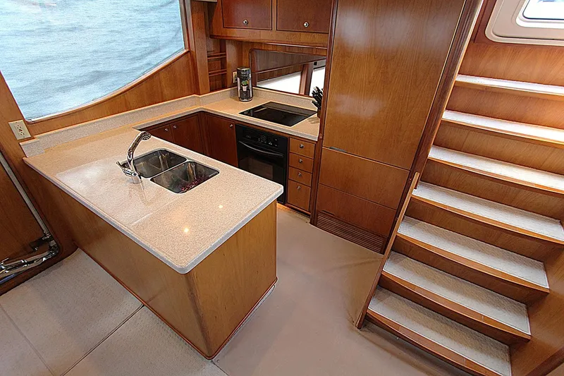 Slide: The Image of Luxurious kitchen in 2001 Symbol 62 Pilothouse yacht with wooden cabinetry and modern appliances. - 14