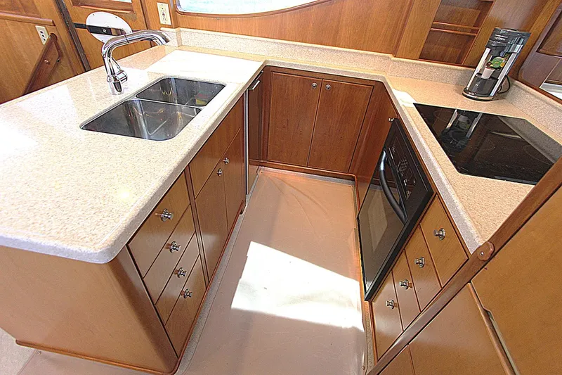 Slide: The Image of Luxurious kitchen in 2001 Symbol 62 Pilothouse yacht with modern appliances and wood cabinetry. - 15