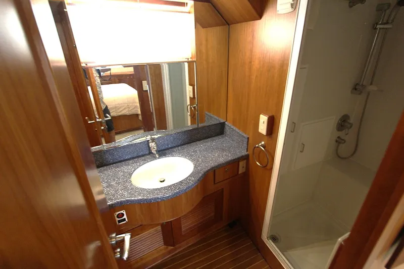 Slide: The Image of Luxurious bathroom in 2001 Symbol 62 Pilothouse yacht with modern sink and shower. - 17